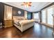 Primary bedroom featuring hard wood flooring, a king bed, and ensuite bathroom at 3437 Coronet Ave, Orlando, FL 32833