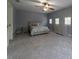 A serene bedroom boasting plush carpeting, a stylish bed, and ample natural light from several windows at 3437 Coronet Ave, Orlando, FL 32833
