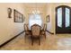 Formal dining room featuring a chandelier, elegant furnishings, and an ornate entrance door at 3437 Coronet Ave, Orlando, FL 32833
