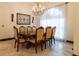 A formal dining area illuminated by a chandelier, adorned with elegant furnishings for a cozy atmosphere at 3437 Coronet Ave, Orlando, FL 32833