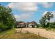 Attractive stucco home with red tile roof and mature trees surrounding circular driveway at 3437 Coronet Ave, Orlando, FL 32833