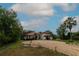 Attractive home boasts a red tile roof, arched windows, and a circular driveway at 3437 Coronet Ave, Orlando, FL 32833