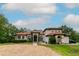 Elegant single-story home with a red tile roof, arched entryway, and circular driveway at 3437 Coronet Ave, Orlando, FL 32833