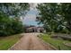 Spacious home with red tile roof, a long driveway, and mature landscaping at 3437 Coronet Ave, Orlando, FL 32833