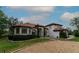 Beautiful single-story home with a tile roof, well-manicured lawn, and circular driveway at 3437 Coronet Ave, Orlando, FL 32833
