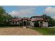 Elegant home featuring a tile roof, arched entryway, and meticulously landscaped yard at 3437 Coronet Ave, Orlando, FL 32833