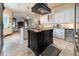 A sleek kitchen with a granite island, white cabinetry, and a view into the open living area at 3437 Coronet Ave, Orlando, FL 32833