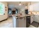 This kitchen features granite counters, stainless appliances, and views into the Gathering room at 3437 Coronet Ave, Orlando, FL 32833