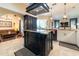 The expansive kitchen flows to the Gathering room and features granite countertops and modern appliances at 3437 Coronet Ave, Orlando, FL 32833