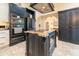 The expansive kitchen features granite countertops, modern appliances, and a wine refrigerator at 3437 Coronet Ave, Orlando, FL 32833