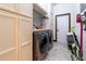 A well-organized laundry room with modern washer and dryer, and ample storage cabinets at 3437 Coronet Ave, Orlando, FL 32833
