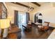 A well-lit living room with hardwood floors, a decorative chandelier, and a sliding glass door to the patio at 3437 Coronet Ave, Orlando, FL 32833
