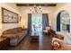 A well-lit living room with hardwood floors, a decorative chandelier, and a sliding glass door to the patio at 3437 Coronet Ave, Orlando, FL 32833