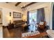 A well-lit living room with hardwood floors, a decorative chandelier, and a sliding glass door to the patio at 3437 Coronet Ave, Orlando, FL 32833
