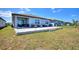 Spacious backyard with a large patio area, perfect for outdoor entertaining and relaxation at 423 Pine Tree Blvd, Lake Alfred, FL 33850
