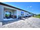Back patio with sliding glass door, offers perfect space for relaxation and entertaining with outdoor furniture at 423 Pine Tree Blvd, Lake Alfred, FL 33850