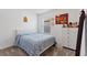Bright bedroom with bed, white dresser, and closet at 423 Pine Tree Blvd, Lake Alfred, FL 33850