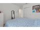 Bedroom featuring blue and white bedspread and large closet at 423 Pine Tree Blvd, Lake Alfred, FL 33850