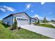 Charming single-story home featuring a two-car garage and well-maintained landscaping with lush grass at 423 Pine Tree Blvd, Lake Alfred, FL 33850