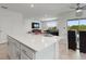 Open-concept kitchen with a large island, seamlessly connecting to the living room for a modern living experience at 423 Pine Tree Blvd, Lake Alfred, FL 33850
