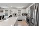 Contemporary kitchen with white cabinets, stainless steel appliances, and an island, ideal for modern living and entertaining at 423 Pine Tree Blvd, Lake Alfred, FL 33850