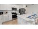 A modern kitchen with stainless steel appliances, white cabinetry, and ample counter space, perfect for cooking and entertaining at 423 Pine Tree Blvd, Lake Alfred, FL 33850