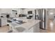 Bright kitchen with a large island, stainless steel appliances, and sleek white cabinetry, offering modern convenience at 423 Pine Tree Blvd, Lake Alfred, FL 33850