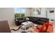 The stylish living room features large windows, tile flooring and modern furnishings at 423 Pine Tree Blvd, Lake Alfred, FL 33850