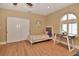 Bedroom with a bed, desk, and arched shuttered window at 434 S Beach St, Ormond Beach, FL 32174