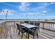 Waterfront deck furnished with a table and chairs, strung with decorative lighting for delightful water views at 434 S Beach St, Ormond Beach, FL 32174