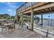 Dock view featuring a boat lift and chairs, set against the backdrop of a tranquil waterfront at 434 S Beach St, Ormond Beach, FL 32174