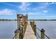 Scenic view of a wooden dock extending into the water with a covered boat lift and observation deck at 434 S Beach St, Ormond Beach, FL 32174