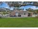 Charming single-story home with a brick facade, inviting patio, and lush green lawn at 434 S Beach St, Ormond Beach, FL 32174