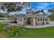 Charming single-story home with a brick facade, inviting patio, and lush green lawn at 434 S Beach St, Ormond Beach, FL 32174