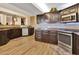 A modern kitchen boasts dark wood cabinetry, granite countertops, stainless appliances, and wood-look flooring at 434 S Beach St, Ormond Beach, FL 32174