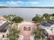Aerial view of a courtyard in front of a lake, featuring palm trees, a fountain, and a gazebo at 4474 Enders St, Orlando, FL 32814