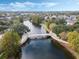 An aerial shot showcasing a bridge over a lake surrounded by trees and neighborhood houses at 4474 Enders St, Orlando, FL 32814