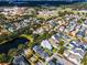 Aerial view of neighborhood homes with community pool and small lake surrounded by trees at 4474 Enders St, Orlando, FL 32814