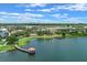 Beautiful aerial view of a community with a lake and various buildings with a city skyline in the background at 4474 Enders St, Orlando, FL 32814