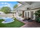 Relax on the covered patio overlooking the pool and lush synthetic grass at 4474 Enders St, Orlando, FL 32814