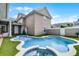A backyard featuring a unique shaped pool, spa, and synthetic grass at 4474 Enders St, Orlando, FL 32814