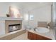 Bright bathroom boasts a fireplace, soaking tub, and large window for natural light at 4474 Enders St, Orlando, FL 32814