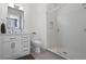 Modern bathroom features a walk-in glass shower, white vanity, and gray flooring at 4474 Enders St, Orlando, FL 32814