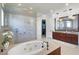 Bathroom offers a glass enclosed shower, soaking tub, vanity, and private commode at 4474 Enders St, Orlando, FL 32814