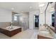 Bathroom featuring double sinks, walk-in shower, soaking tub, and walk in closet at 4474 Enders St, Orlando, FL 32814