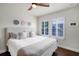 Bright bedroom featuring hardwood floors, white bedding, and plantation shutters at 4474 Enders St, Orlando, FL 32814