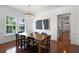Well-lit dining room with a large wooden table, chandelier, and views to the kitchen area at 4474 Enders St, Orlando, FL 32814