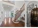 Spacious foyer featuring hardwood floors, a staircase, and a wrought iron gate to the wine cellar at 4474 Enders St, Orlando, FL 32814