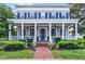 Charming two-story home featuring a welcoming front porch with columns and manicured landscaping at 4474 Enders St, Orlando, FL 32814