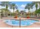 Inviting hot tub area surrounded by palm trees and lush landscaping, creating a serene and relaxing atmosphere at 4474 Enders St, Orlando, FL 32814